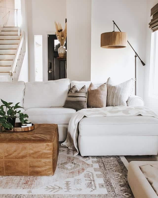 19. Cream and Caramel Living Room with Leather Ottoman - earth tones living room ideas