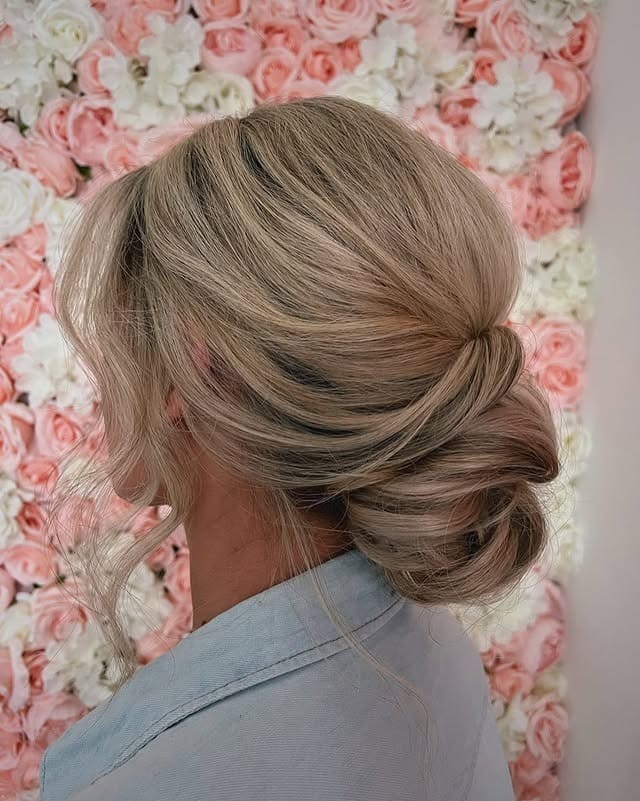 6. Champagne Blonde Voluminous Low Bun - Elegant Hairstyles