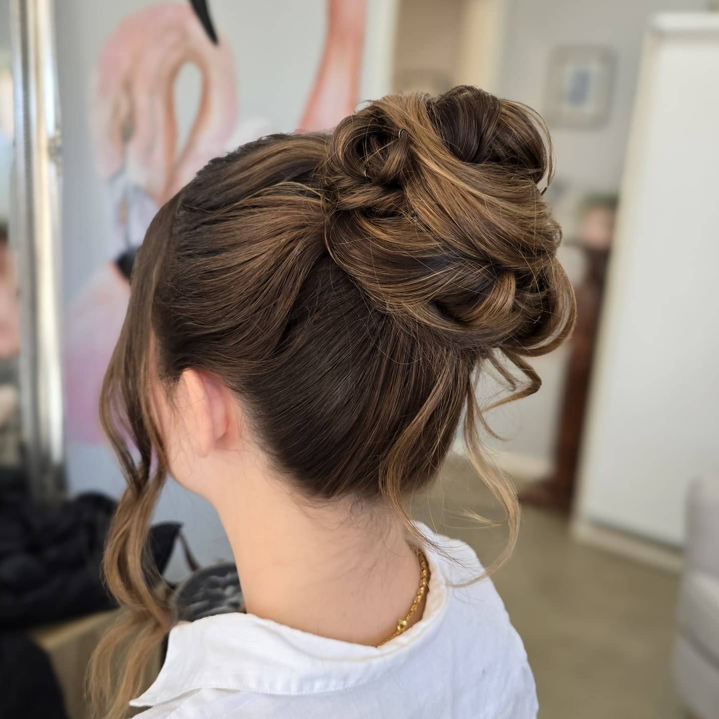 17. Brunette Textured High Bun with Face-Framing Strands - Elegant Hairstyles