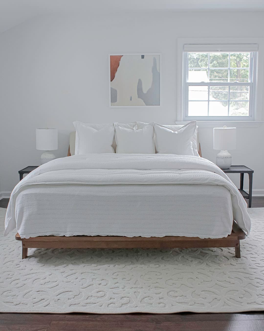 3. Minimal White Bedroom with Warm Wood Bed Frame - white bedroom ideas