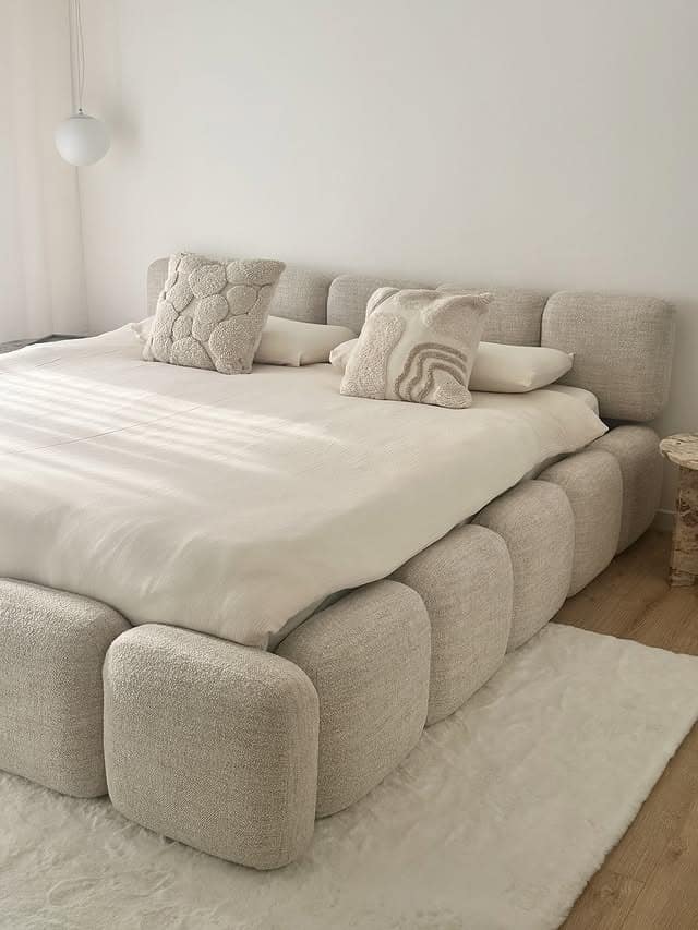 10. Soft Cream and White Bedroom with Sculptural Upholstered Bed - white bedroom ideas
