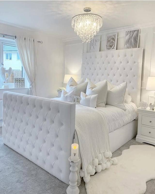 20. Glam White Bedroom with Tufted Upholstery and Crystal Chandelier - white bedroom ideas