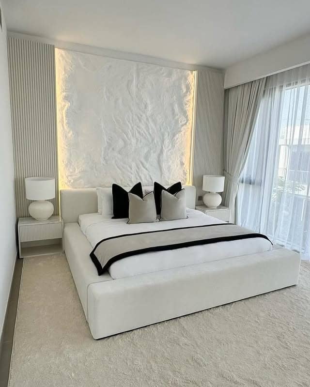 21. Modern White Bedroom with Textured Feature Wall and Black Accents - white bedroom ideas