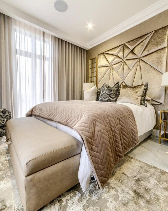 9. Elegant Earth Tone Bedroom with Champagne Beige and Sculpted Wall Panels - earth tones bedroom ideas