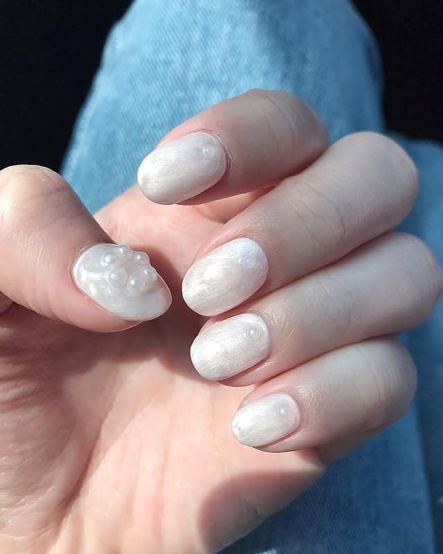 1. Pearlescent Off White Almond Nails with Raised Pearl Accent - off white nail ideas