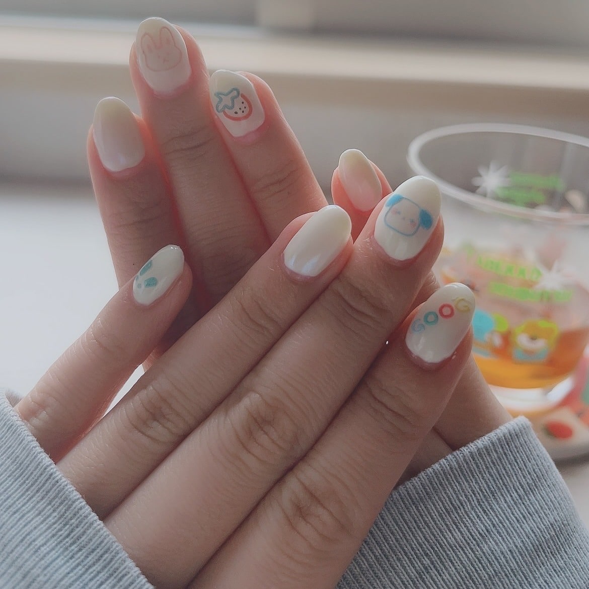 3. Playful Off White Almond Nails with Cute Character Nail Art - off white nail ideas