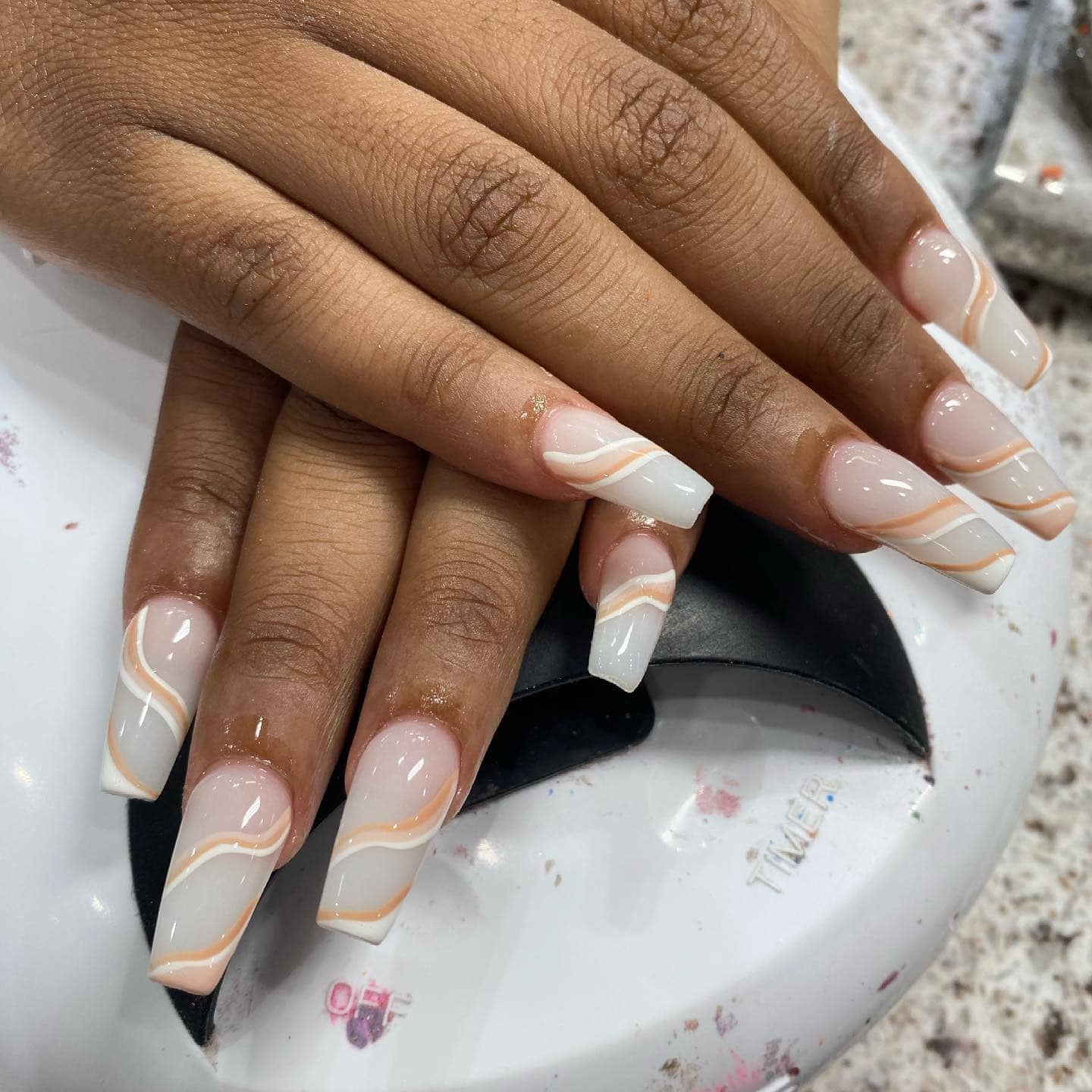 4. Off White Square Acrylic Nails with Peach Wave Line Art - off white nail ideas