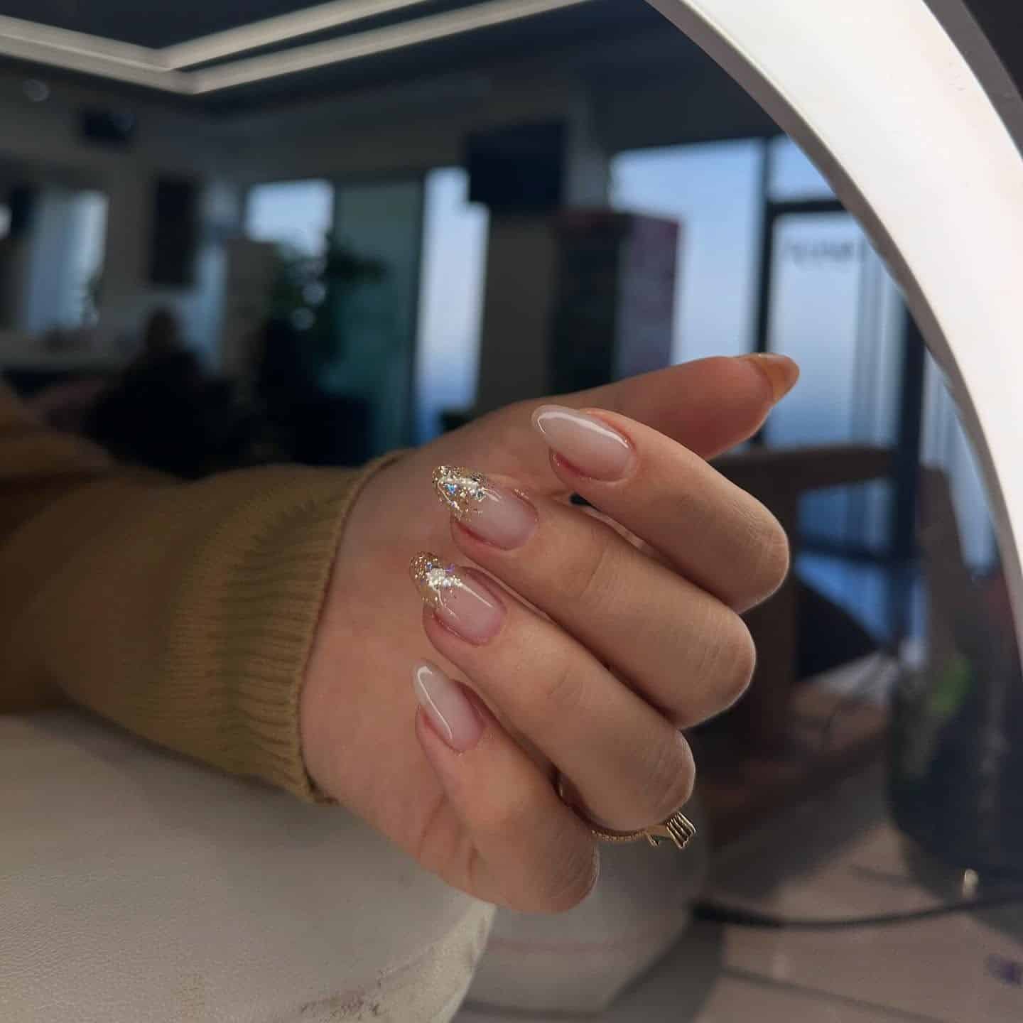 15. Sheer Off White Almond Nails with Glitter French Tips - off white nail ideas