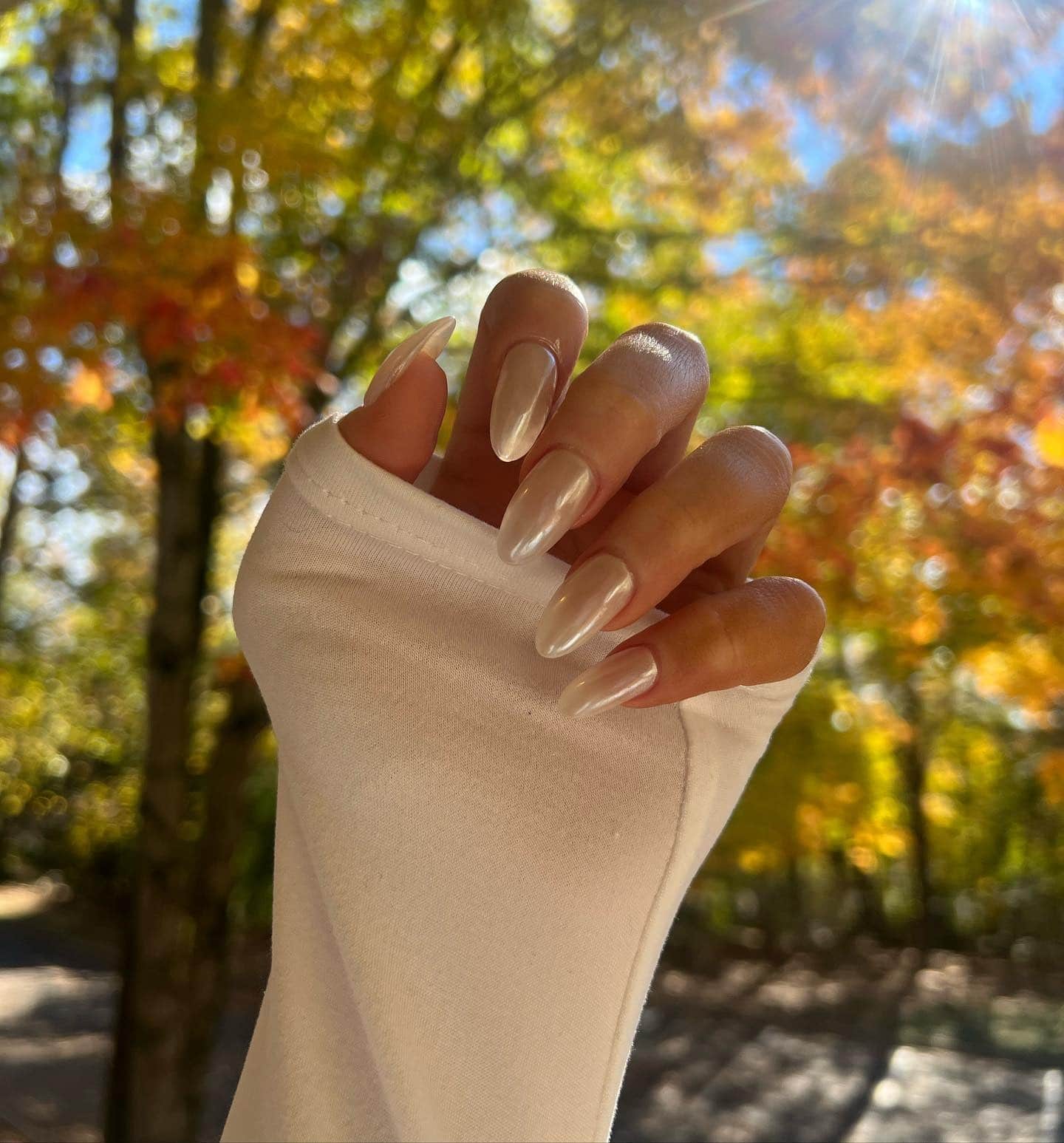20. Pearlescent Off White Almond Nails with Chrome Finish - off white nail ideas