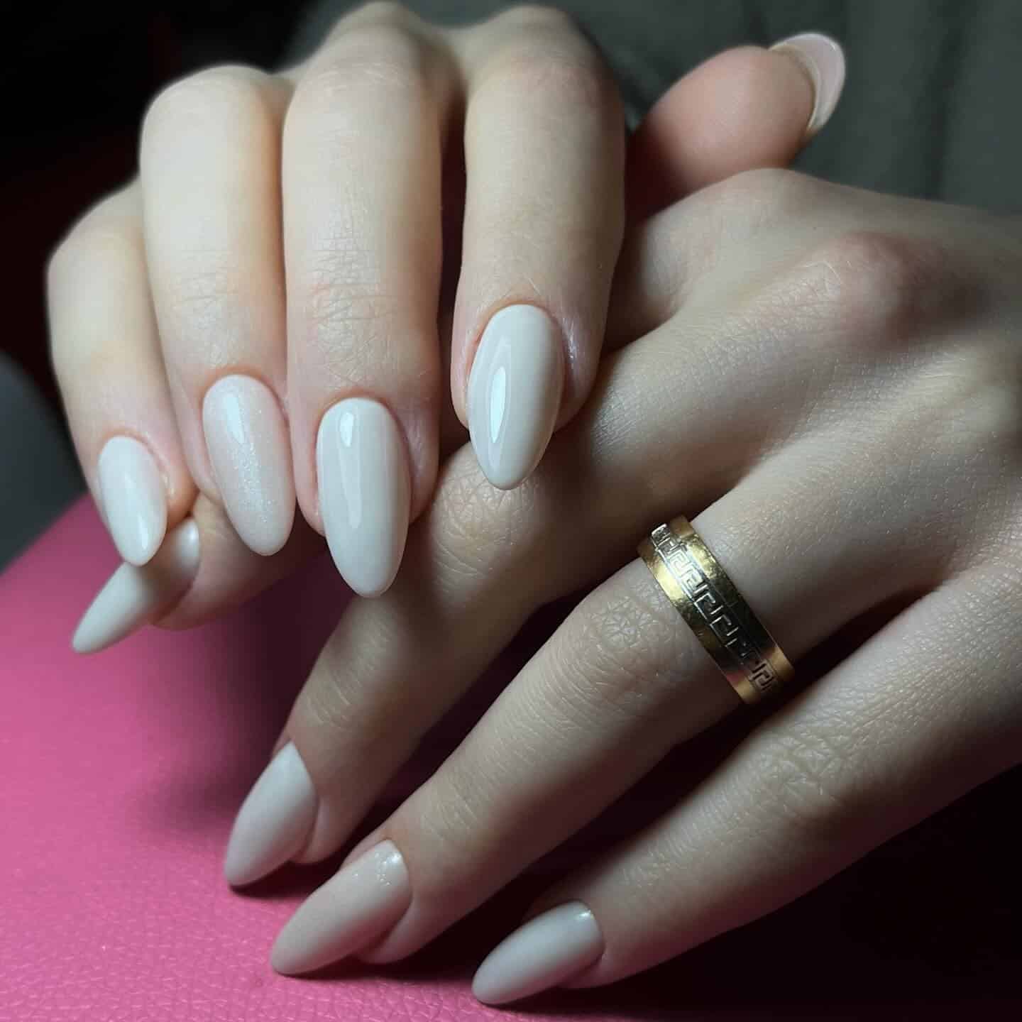 21. Glossy Off White Almond Nails with Subtle Shimmer Accent - off white nail ideas
