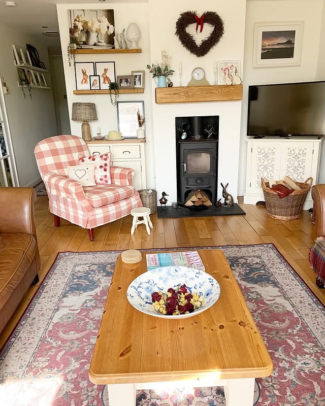 2. Cozy Cottage Living Room with Blush Checks and White Wood Details - country living room ideas