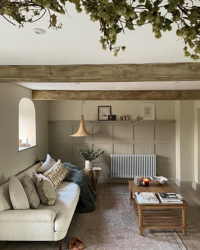 6. Minimal Rustic Country Living Room with Wood Beams and Paneling - country living room ideas