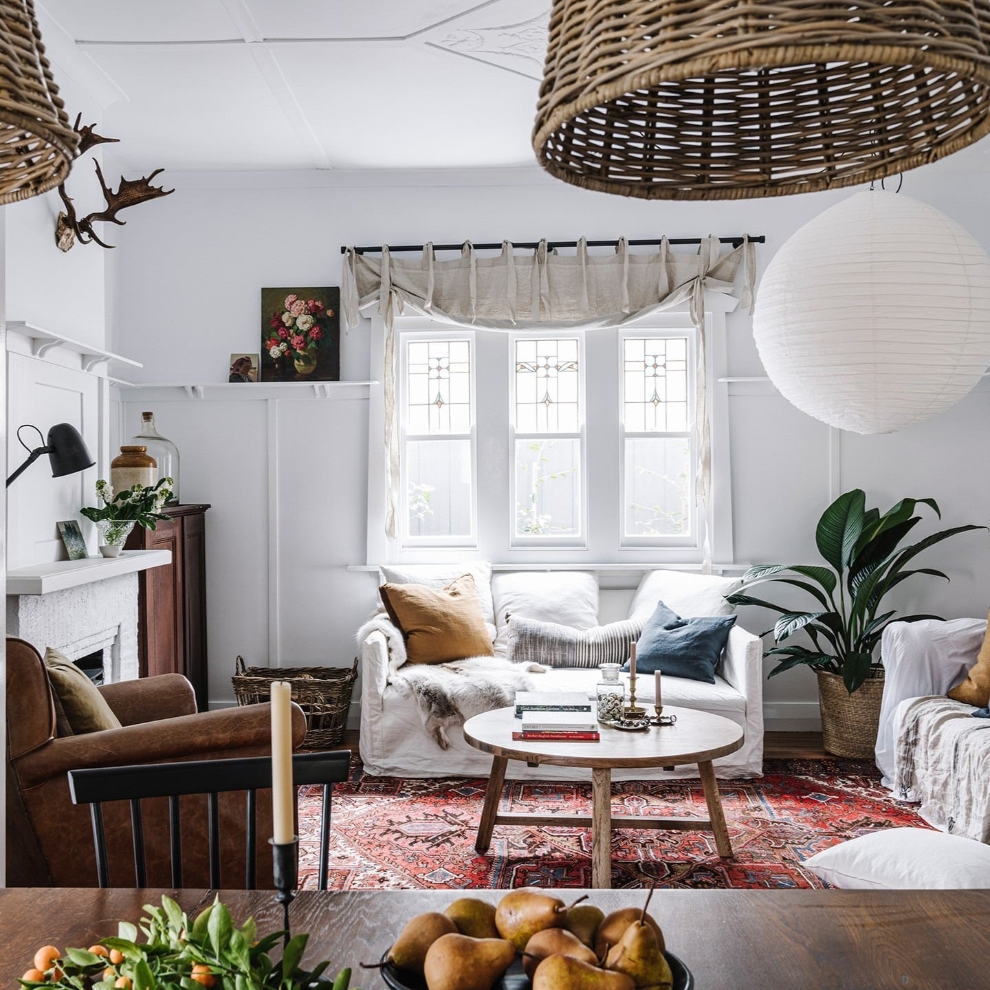 12. Bright Country Living Room with White Walls and Vintage Red Rug - country living room ideas
