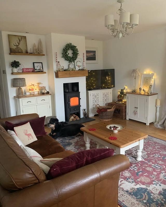 15. Festive Country Living Room with Leather Sofa and Deep Red Textiles - country living room ideas