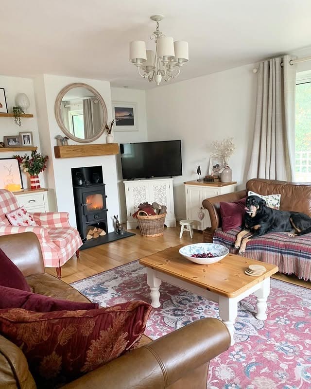 16. Cozy Cottage Living Room with Checked Armchair and Natural Wood - country living room ideas