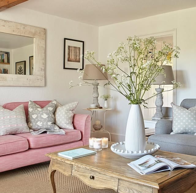 20. Charming Cottage Living Room with Blush Sofa and Classic Wood Furniture - country living room ideas