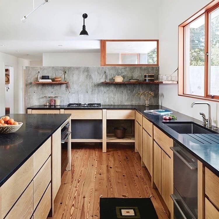 2. Natural Wood Industrial Kitchen with Concrete Wall and Black Countertops - industrial kitchen ideas
