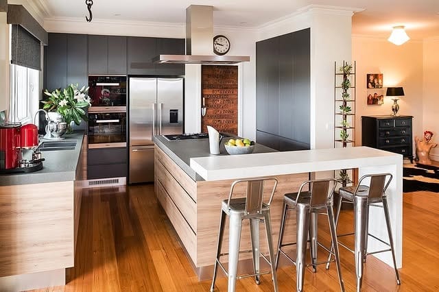 4. Contemporary Industrial Kitchen with Wood Island and Matte Gray Cabinets - industrial kitchen ideas
