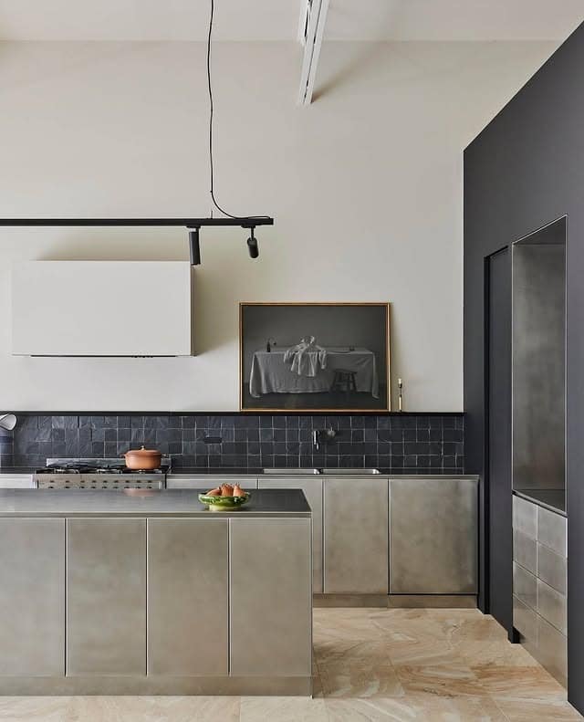 15. Concrete Industrial Kitchen with Textured Tile Backsplash and Metal Cabinets - industrial kitchen ideas