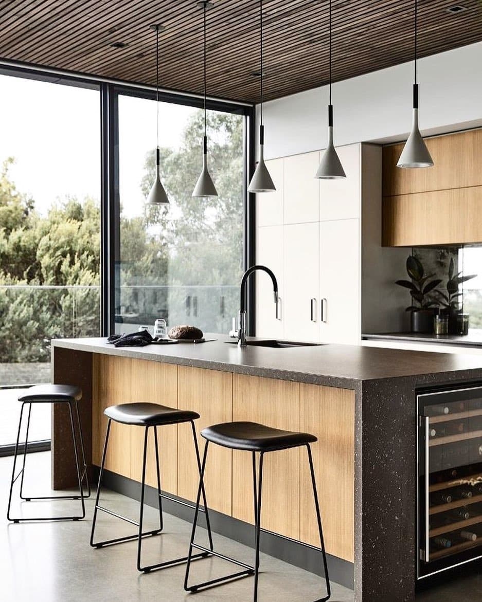 20. Modern Industrial Kitchen with Wood Island Paneling and Black Accents - industrial kitchen ideas