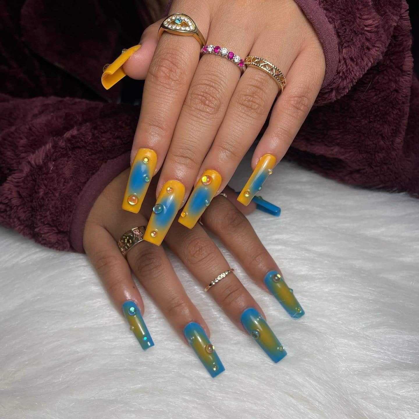 1. Long Coffin Orange and Blue Aura Nails with Crystal Accents - orange and blue nail ideas