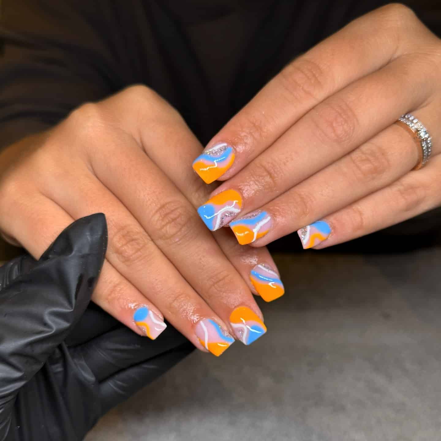 6. Short Abstract Orange and Blue Swirl Nails - orange and blue nail ideas