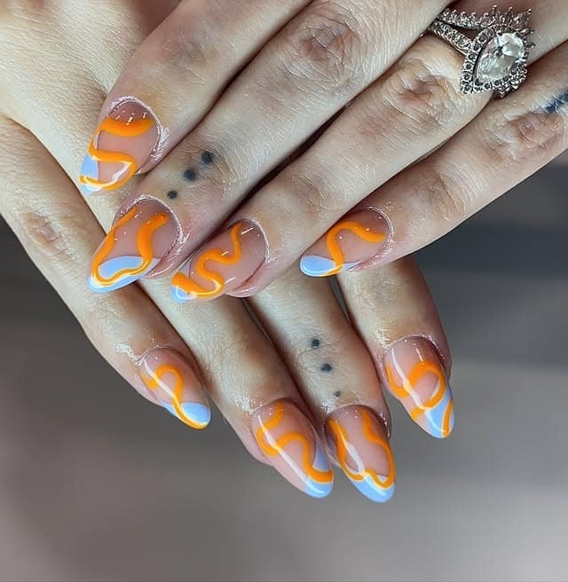 8. Short Nude Nails with Orange and Blue Squiggle Art - orange and blue nail ideas