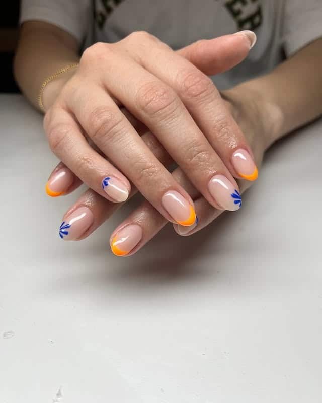 17. Short Nude Nails with Orange Micro French Tips and Blue Floral Accents - orange and blue nail ideas