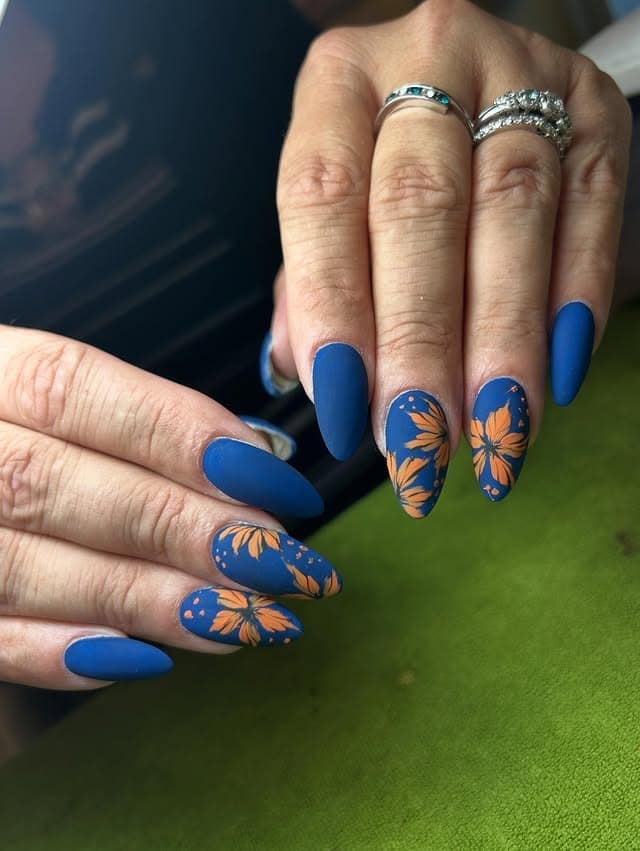 20. Matte Blue Almond Nails with Orange Floral Accent Art - orange and blue nail ideas