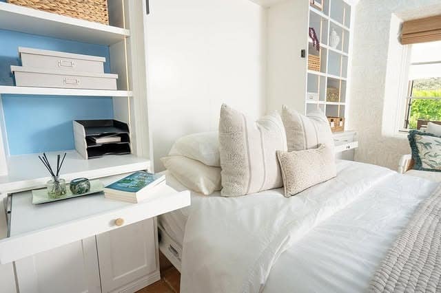 13. Bright White Bedroom Office With Built-In Shelving and Workspace - home office bedroom ideas