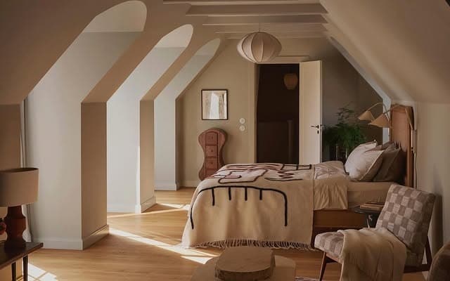 7. Warm Neutral Loft Bedroom with Arched Ceiling Details - loft bedroom ideas