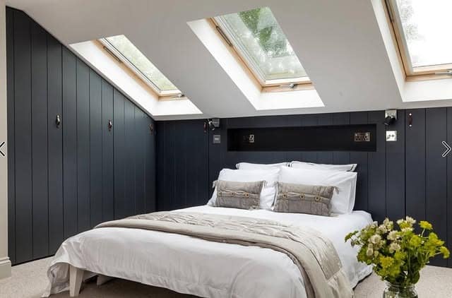 8. Contemporary Loft Bedroom with Dark Panel Accent Wall - loft bedroom ideas