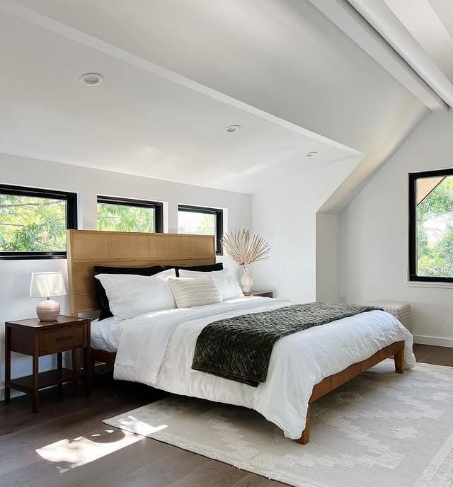 10. Modern Loft Bedroom with Wood Headboard and Black Window Frames - loft bedroom ideas