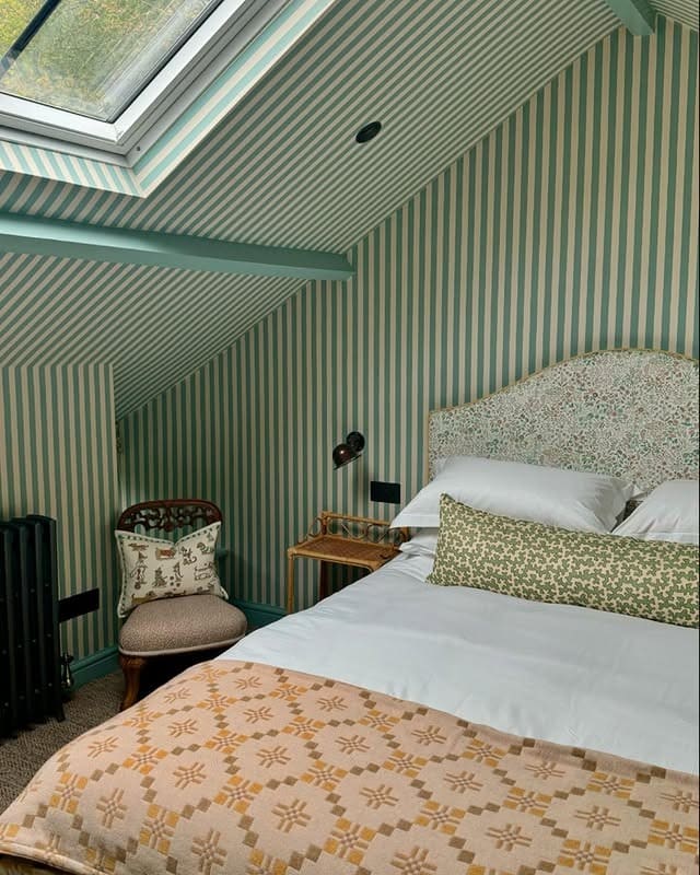 19. Green and Cream Striped Loft Bedroom with Vintage Accents - loft bedroom ideas