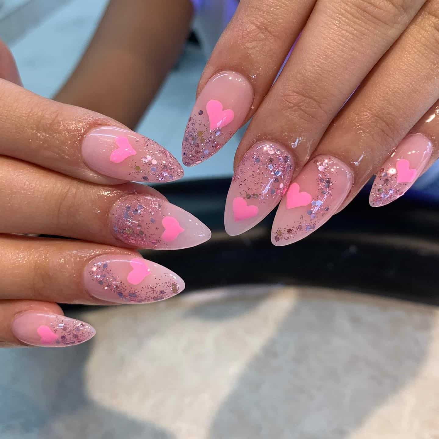 5. Blush Almond Nails with Glitter Fade and Pink Heart Accents - pink heart nail ideas