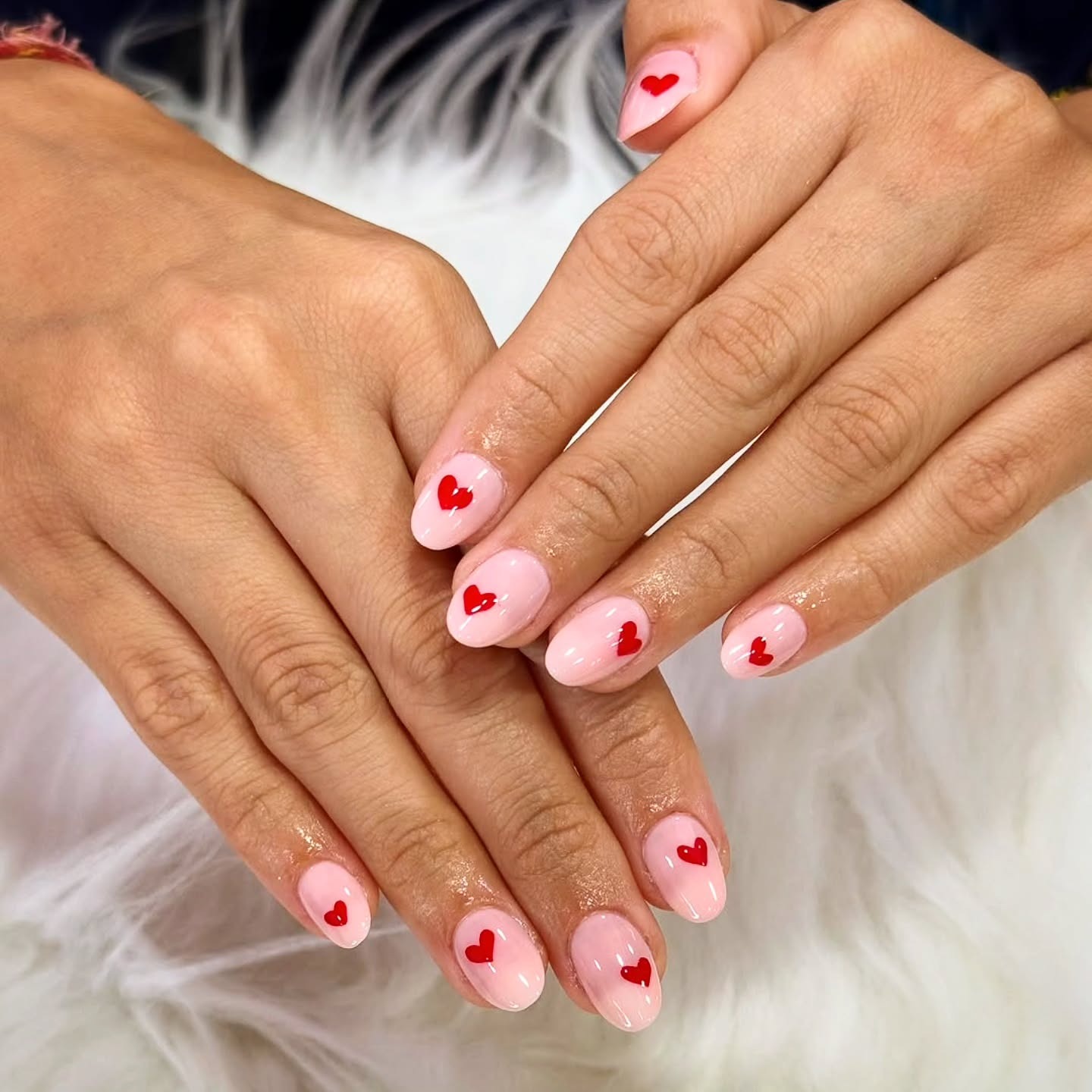 16. Baby Pink Short Oval Nails with Classic Red Heart Accents - pink heart nail ideas