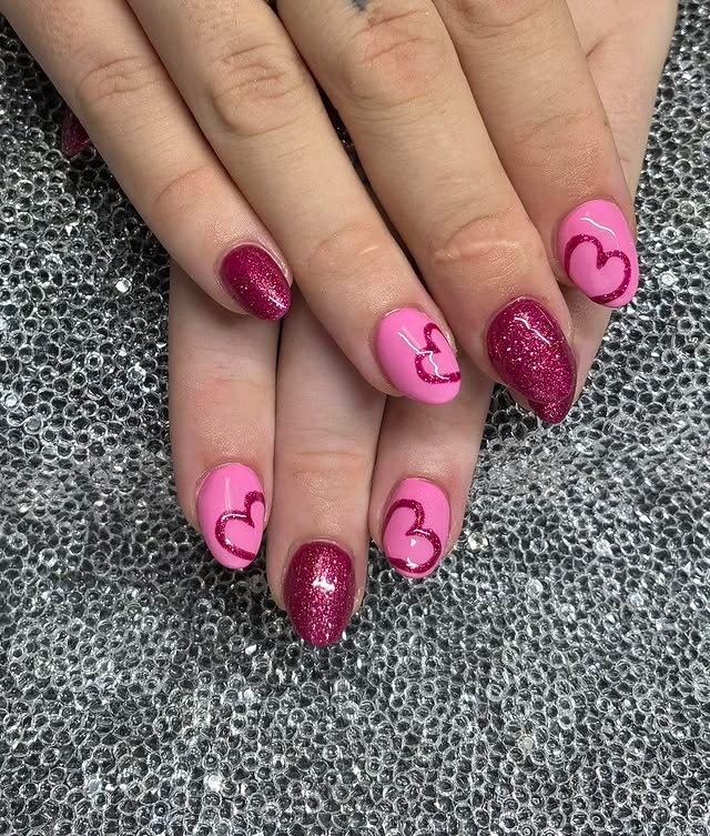 19. Pink Glitter Almond Nails with Hand-Painted Heart Art - pink heart nail ideas