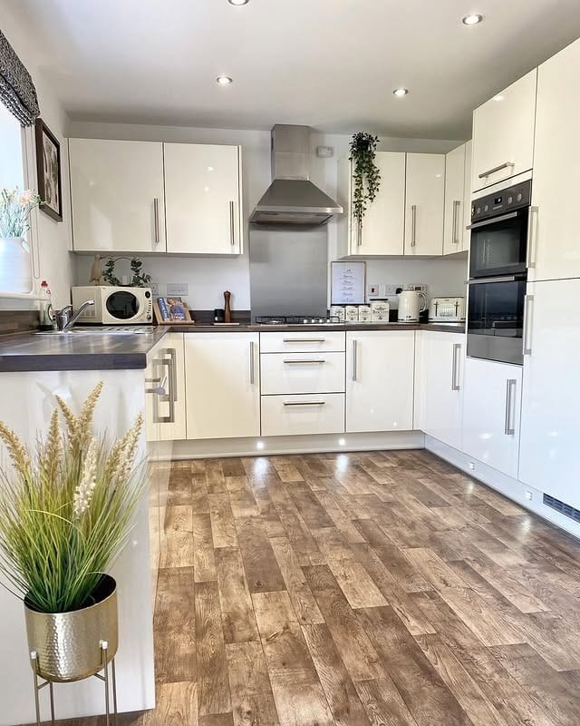 1. Minimal Cream Kitchen With Warm Wood Flooring - cream kitchen ideas