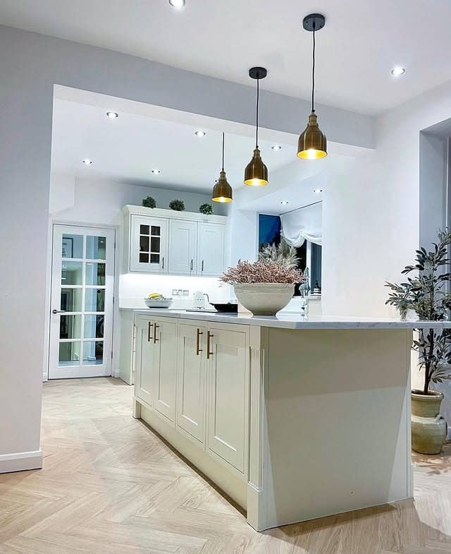 6. Cream Kitchen With Brass Pendant Lighting and Herringbone Floor - cream kitchen ideas