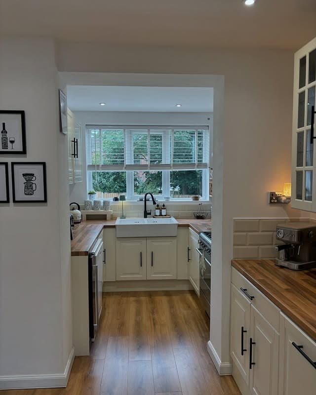 10. Compact Cream Kitchen With Farmhouse Sink and Wood Worktops - cream kitchen ideas