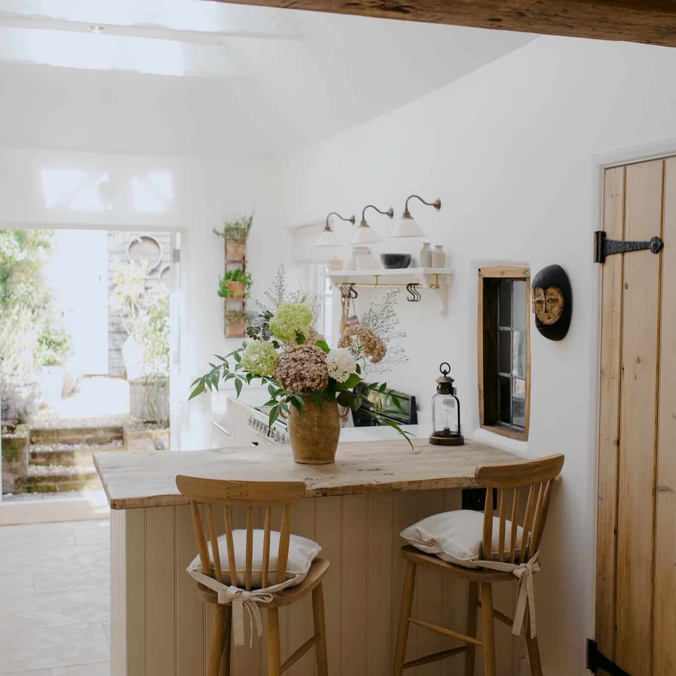 11. Rustic Cream Kitchen With Wood Countertop Breakfast Bar - cream kitchen ideas
