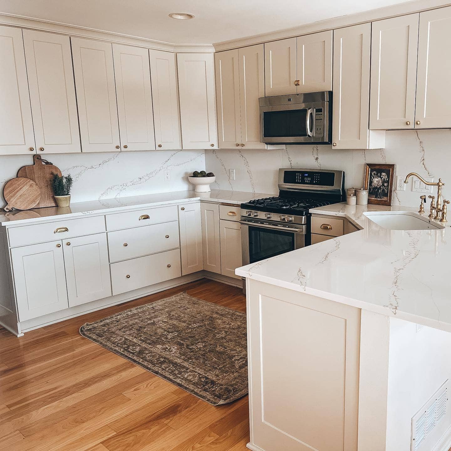 12. Traditional Cream Kitchen With Quartz Countertops and Brass Hardware - cream kitchen ideas
