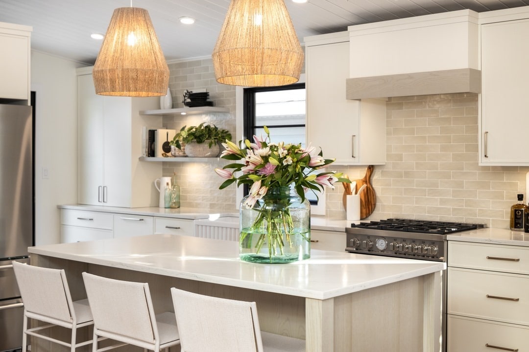 15. Contemporary Cream Kitchen With Waterfall Island and Woven Pendant Lights - cream kitchen ideas
