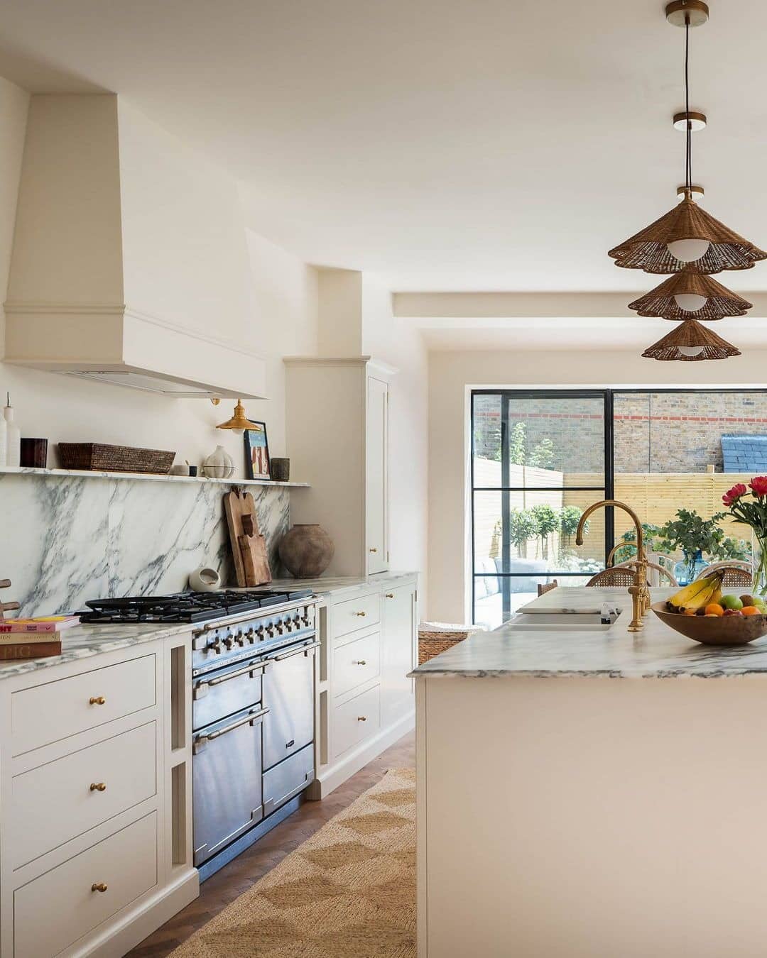16. Cream Kitchen With Marble Backsplash and Brass Fixtures - cream kitchen ideas