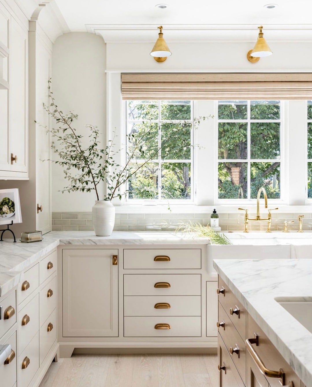 19. Cream Kitchen With Marble Counters and Brass Wall Sconces - cream kitchen ideas