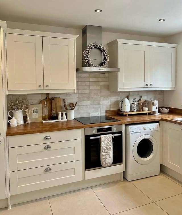 22. Cream Kitchen With Wood Worktops and Soft Neutral Tile Backsplash - cream kitchen ideas