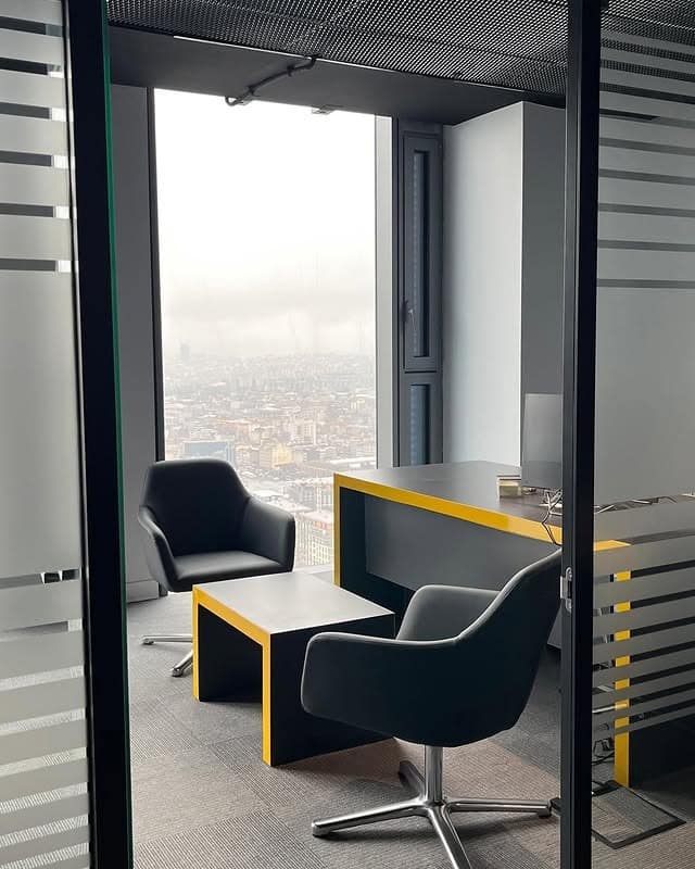 10. Contemporary Glass Office with City View and Charcoal Furniture - small office ideas