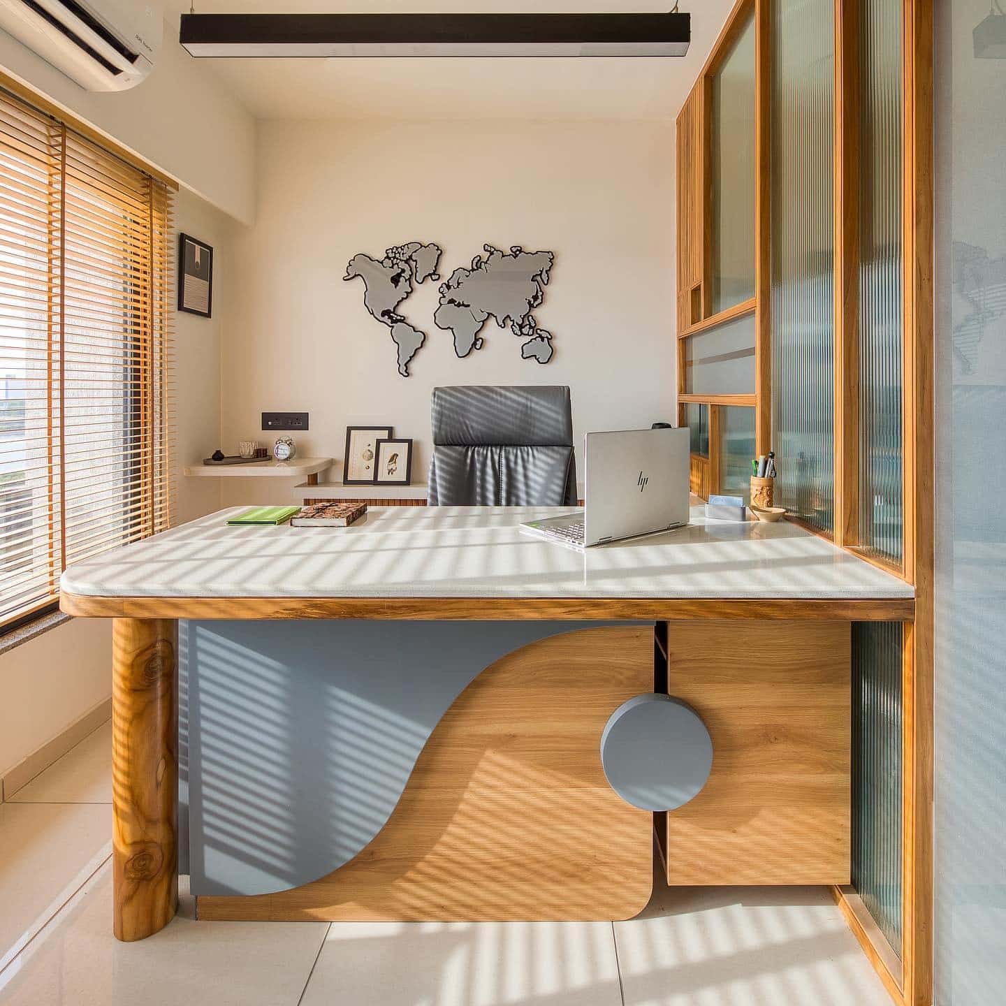 20. Modern Wood Office with Sculptural Desk and World Map Wall Art - small office ideas