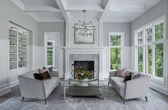 21. Elegant Light Gray Living Room with Classic Panel Molding - light gray living room ideas