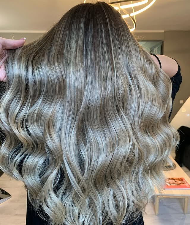 6. Cool Sandy Blonde Silky Waves - Sandy Hair Color